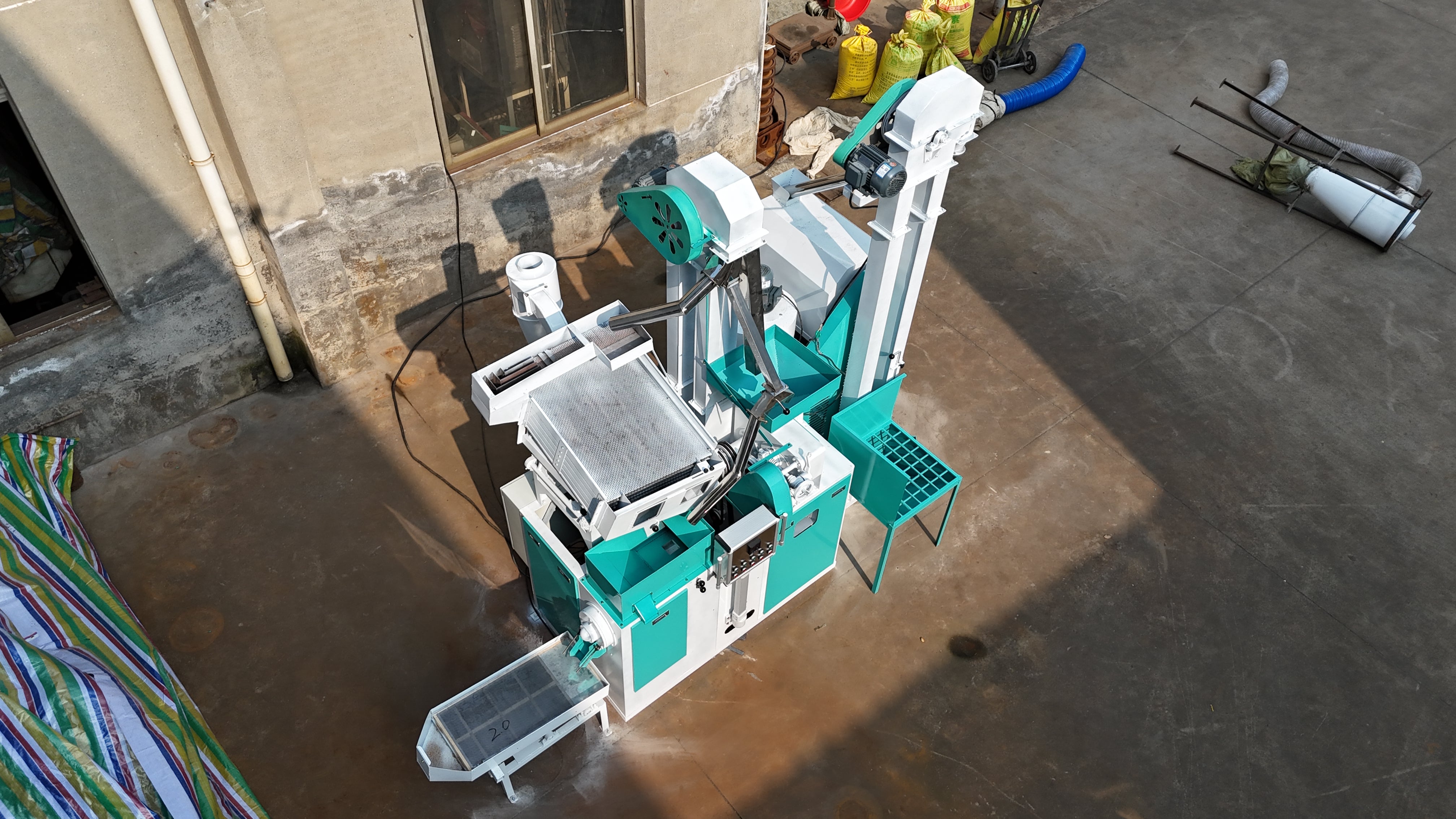 Robotic arm in a workshop setting with tools and equipment around